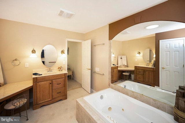 full bath with a whirlpool tub and two vanities