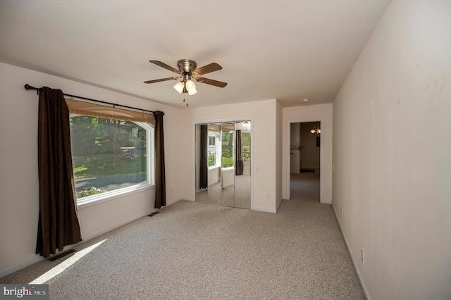 empty room with light carpet, baseboards, and ceiling fan
