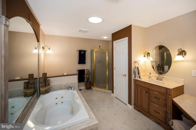 full bathroom featuring a stall shower, a tub with jets, and vanity