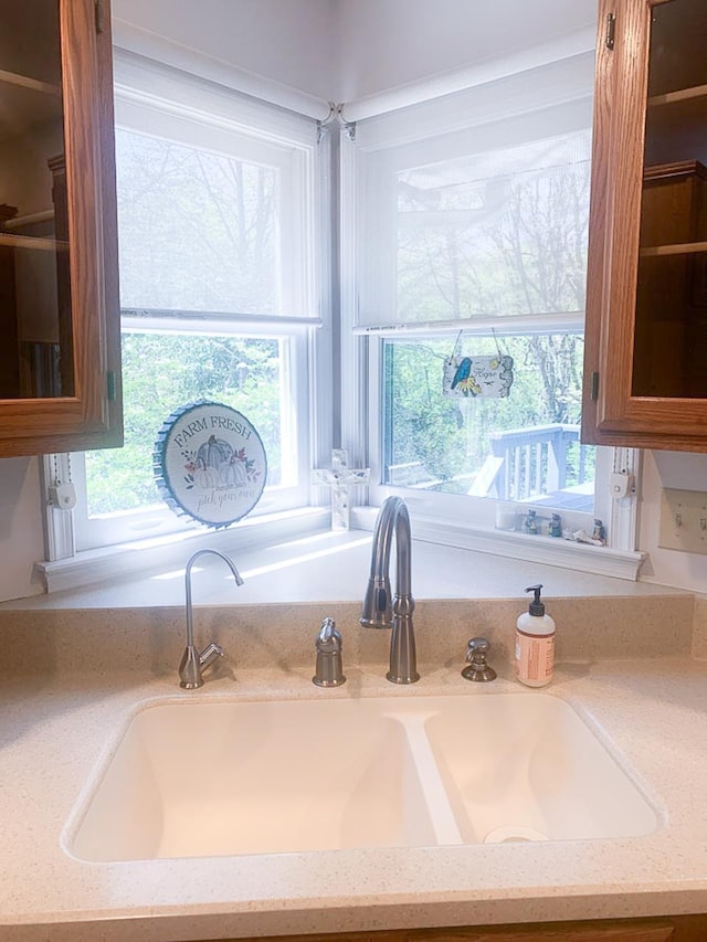 209 Raintree Rd, Verona, VA 24482 - kitchen view of a sink, glass insert cabinets, and light stone counters