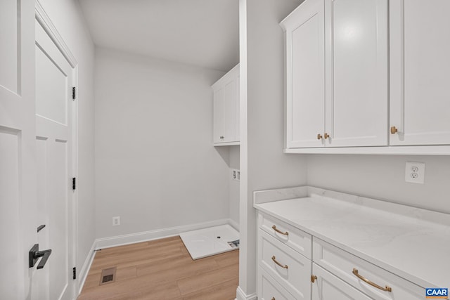 1367 Laconia Ln, Charlottesville, VA 22911 - laundry area featuring light wood-style floors and cabinet space