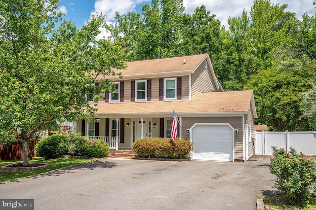 11603 Enchanted Woods Way, Fredericksburg, VA 22407 - colonial-style house with a porch, asphalt driveway, and an attached garage