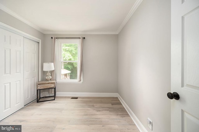 11603 Enchanted Woods Way, Fredericksburg, VA 22407 - unfurnished bedroom with light wood-type flooring, a closet, ornamental molding, and baseboards