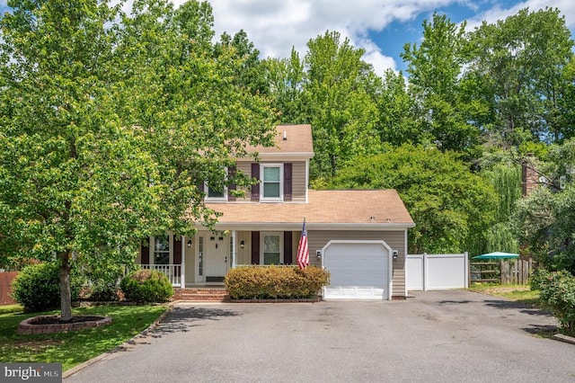 11603 Enchanted Woods Way, Fredericksburg, VA 22407 - view of front facade featuring an attached garage, covered porch, and asphalt driveway