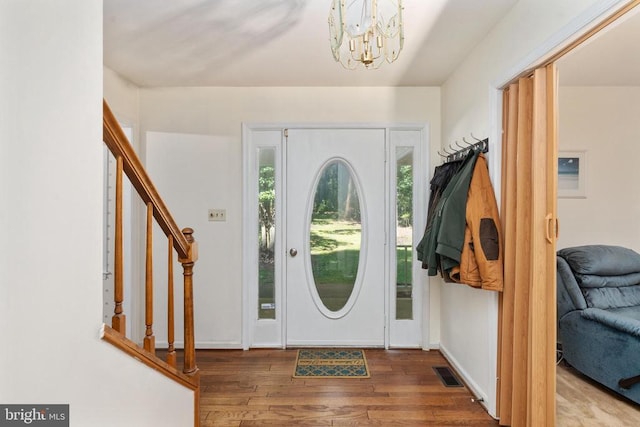 13403 Motts Run Rd, Fredericksburg, VA 22407 - foyer entrance with wood finished floors, a chandelier, stairs, and baseboards