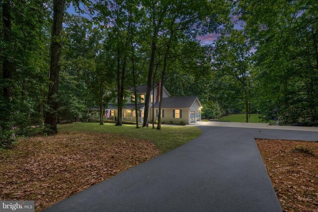 13403 Motts Run Rd, Fredericksburg, VA 22407 - colonial home with asphalt driveway, a front yard, and a garage