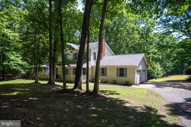 13403 Motts Run Rd, Fredericksburg, VA 22407 - view of front of home with asphalt driveway, a garage, and a chimney
