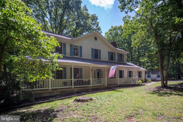 13403 Motts Run Rd, Fredericksburg, VA 22407 - farmhouse inspired home with a chimney, covered porch, and a front yard