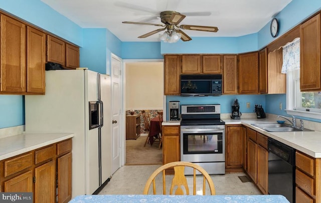 13403 Motts Run Rd, Fredericksburg, VA 22407 - kitchen featuring black appliances, a sink, brown cabinetry, and light countertops