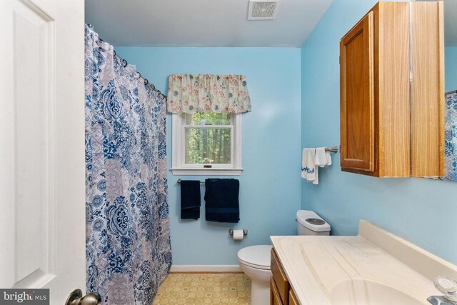 13403 Motts Run Rd, Fredericksburg, VA 22407 - bathroom featuring vanity, toilet, tile patterned floors, curtained shower, and baseboards
