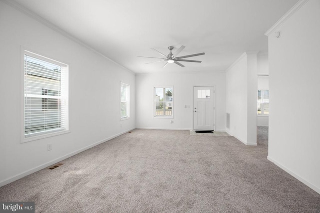 unfurnished living room featuring crown molding, ceiling fan, carpet flooring, and baseboards