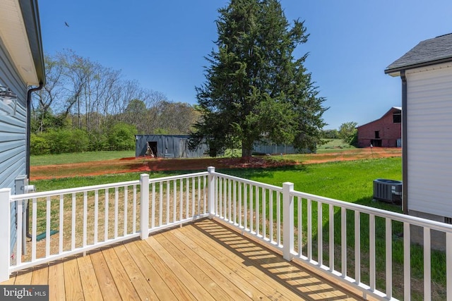 wooden deck featuring a yard and cooling unit