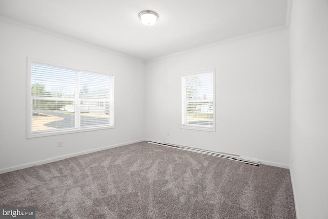 carpeted empty room featuring ornamental molding and baseboards