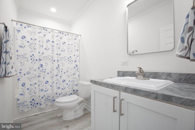 bathroom featuring crown molding, wood finished floors, toilet, vanity, and recessed lighting