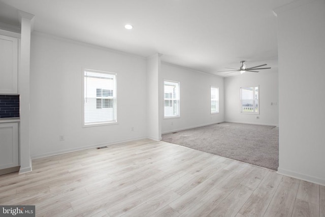 unfurnished living room featuring ornamental molding, ceiling fan, light wood-style floors, baseboards, and recessed lighting
