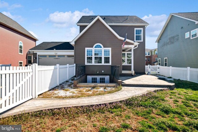 back of house featuring a gate and a fenced backyard