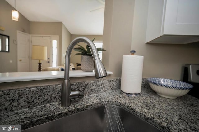 10118 New Scotland Dr, Fredericksburg, VA 22408 - kitchen view of a sink, stone counters, and white cabinetry