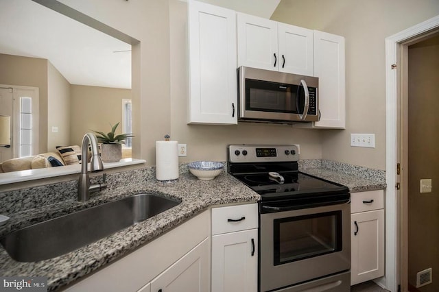 10118 New Scotland Dr, Fredericksburg, VA 22408 - kitchen featuring appliances with stainless steel finishes, a sink, white cabinets, and light stone counters
