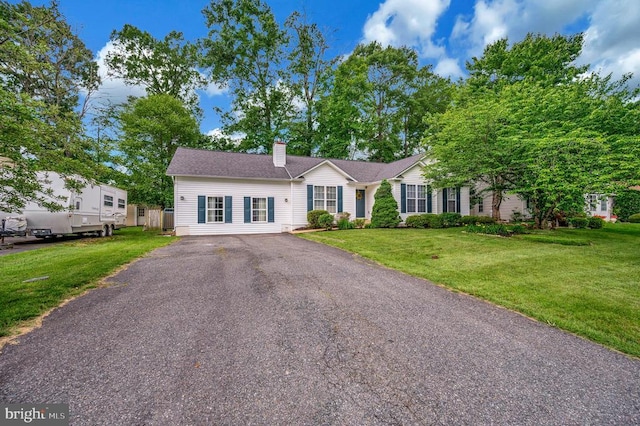 10118 New Scotland Dr, Fredericksburg, VA 22408 - ranch-style home featuring a chimney, a front yard, and asphalt driveway