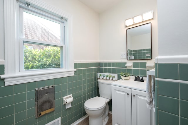 928 Baylor St, Staunton, VA 22401 - bathroom with toilet, vanity, tile walls, and a wainscoted wall