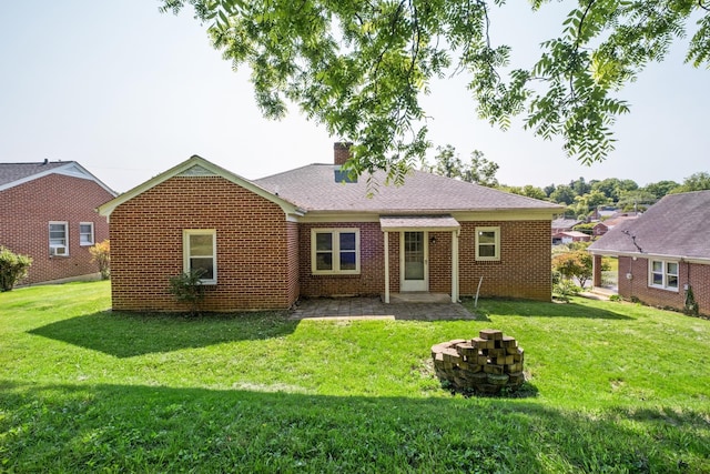 928 Baylor St, Staunton, VA 22401 - back of property featuring a lawn, a chimney, and brick siding