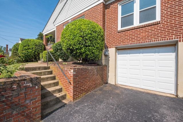 928 Baylor St, Staunton, VA 22401 - view of side of property featuring brick siding, an attached garage, and driveway