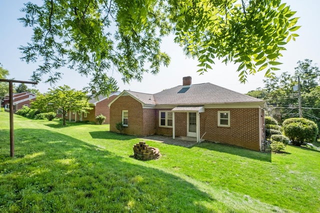 928 Baylor St, Staunton, VA 22401 - back of property featuring brick siding, a yard, a chimney, and a fire pit