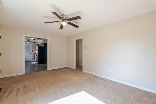 109 Jackson Ave, Elkton, VA 22827 - spare room with a ceiling fan, carpet floors, and baseboards