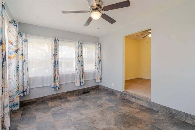 109 Jackson Ave, Elkton, VA 22827 - spare room with stone finish flooring, ceiling fan, and baseboards