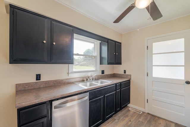 109 Jackson Ave, Elkton, VA 22827 - kitchen with dishwasher, dark cabinetry, a sink, light wood-type flooring, and crown molding