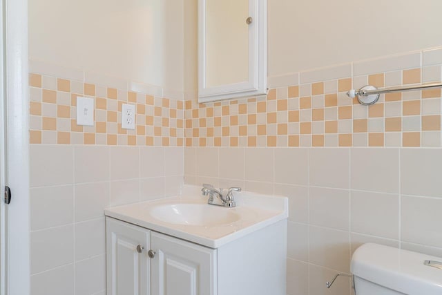 109 Jackson Ave, Elkton, VA 22827 - bathroom with tile walls, vanity, toilet, and decorative backsplash