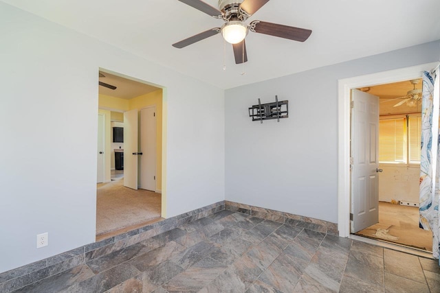 109 Jackson Ave, Elkton, VA 22827 - empty room featuring ceiling fan, stone finish floors, and baseboards