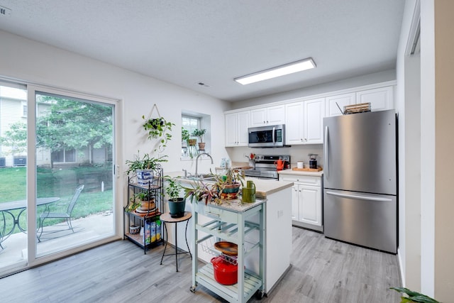 1045 Alexander Hamilton Ln, Harrisonburg, VA 22802 - kitchen with appliances with stainless steel finishes, light wood-style flooring, a sink, and white cabinets