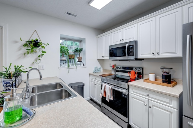 1045 Alexander Hamilton Ln, Harrisonburg, VA 22802 - kitchen featuring stainless steel appliances, a sink, white cabinets, and light countertops