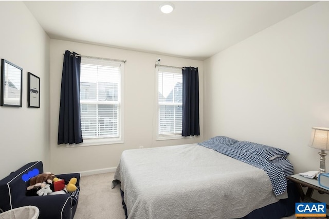 carpeted bedroom featuring baseboards