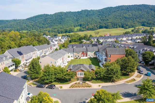 bird's eye view featuring a forest view and a residential view