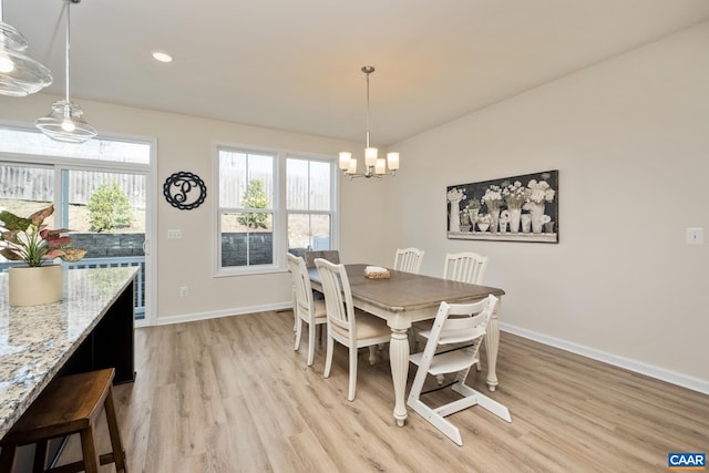 dining area featuring baseboards, light wood-style floors, a chandelier, and recessed lighting
