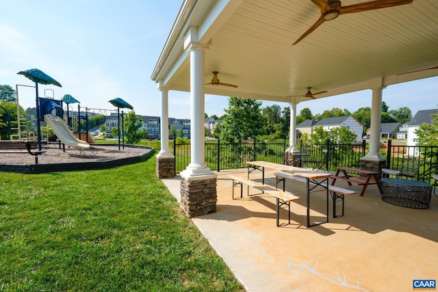 view of patio featuring playground community, fence, and ceiling fan