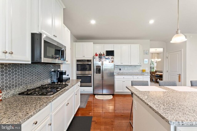 12804 Monterey Ct, Fredericksburg, VA 22407 - kitchen with stainless steel appliances, wood finished floors, white cabinetry, decorative backsplash, and recessed lighting