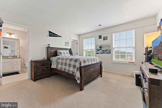 12804 Monterey Ct, Fredericksburg, VA 22407 - bedroom with baseboards, light carpet, ensuite bathroom, and a sink