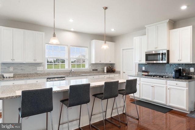 12804 Monterey Ct, Fredericksburg, VA 22407 - kitchen featuring stainless steel appliances, tasteful backsplash, a breakfast bar, white cabinets, and recessed lighting