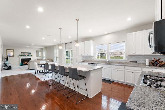 12804 Monterey Ct, Fredericksburg, VA 22407 - kitchen with a sink, tasteful backsplash, stainless steel appliances, open floor plan, and light stone counters