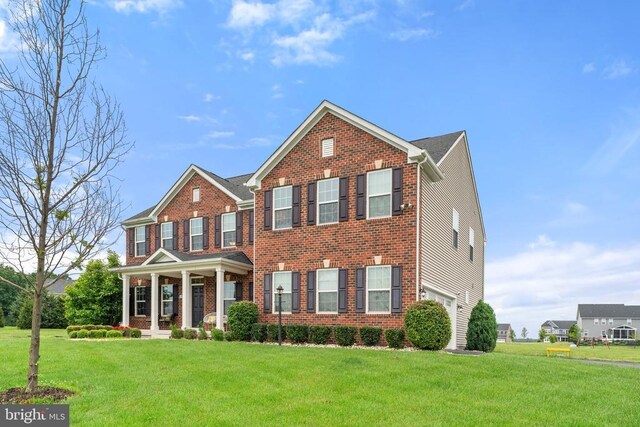 12804 Monterey Ct, Fredericksburg, VA 22407 - view of front of home with a front lawn, brick siding, a garage, and a porch