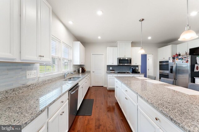12804 Monterey Ct, Fredericksburg, VA 22407 - kitchen featuring appliances with stainless steel finishes, a sink, decorative backsplash, white cabinets, and dark wood-style flooring