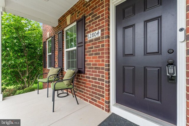 12804 Monterey Ct, Fredericksburg, VA 22407 - doorway to property with a porch and brick siding