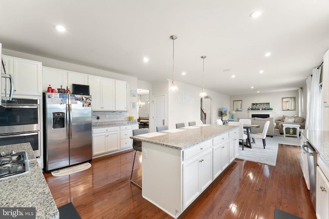 12804 Monterey Ct, Fredericksburg, VA 22407 - kitchen featuring stainless steel appliances, a center island, dark wood-style floors, white cabinets, and recessed lighting