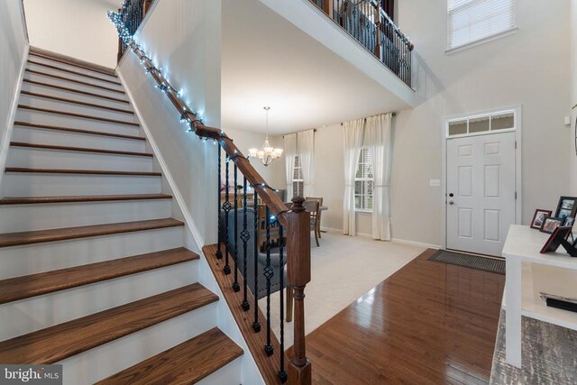12804 Monterey Ct, Fredericksburg, VA 22407 - foyer with a chandelier, stairway, wood finished floors, a high ceiling, and baseboards