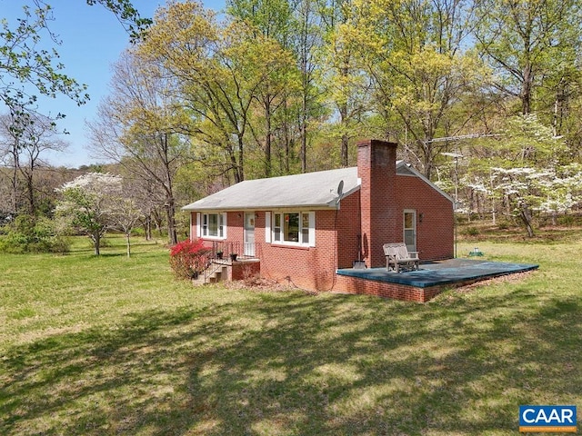 6928 Blackwells Hollow Rd, Crozet, VA 22932 - view of home's exterior with a chimney, a lawn, brick siding, and a wooden deck