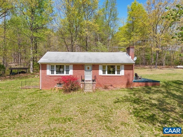 6928 Blackwells Hollow Rd, Crozet, VA 22932 - view of front of house featuring a chimney, a front yard, brick siding, and a view of trees