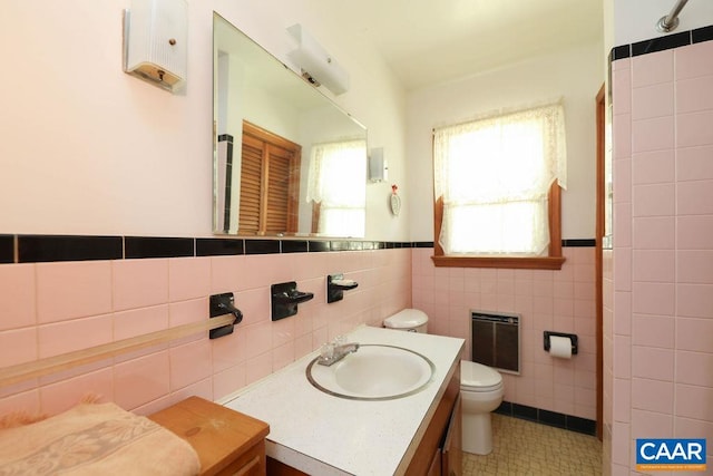 6928 Blackwells Hollow Rd, Crozet, VA 22932 - full bathroom with tile walls, heating unit, toilet, vanity, and tile patterned floors